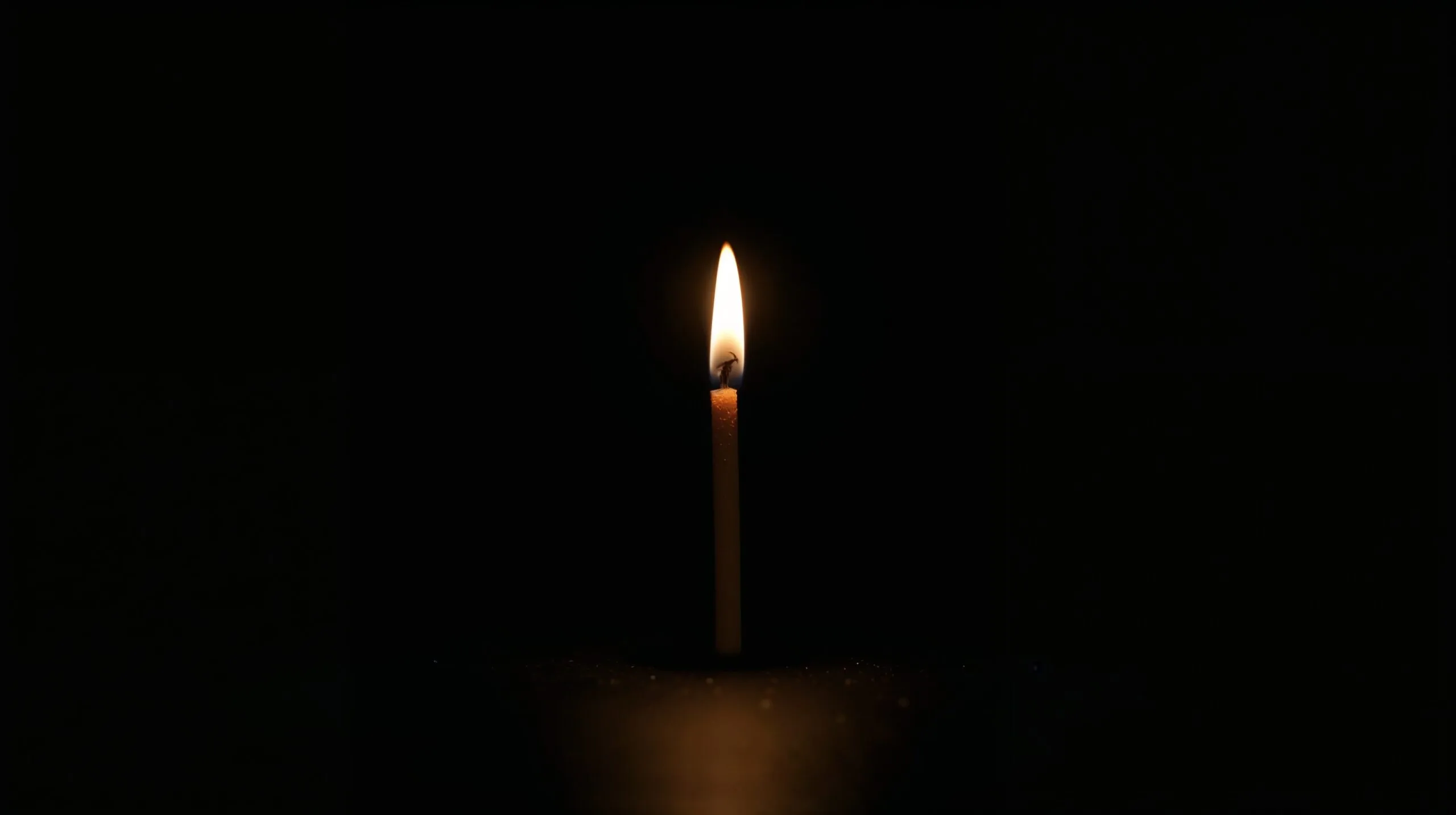 A single lit match illuminating the darkness